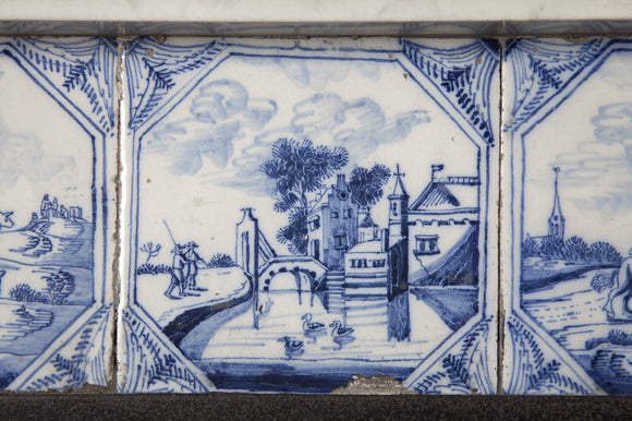 Blue and white Delft tiles in the fireplace surround in the Entrance Hall at Gunby Hall, Lincolnshire