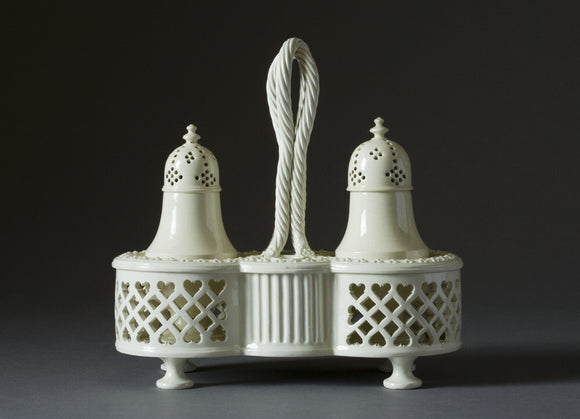 A creamware cruet set and stand, with pierced sides and a basket pattern woven handle at Hinton Ampner, Hampshire