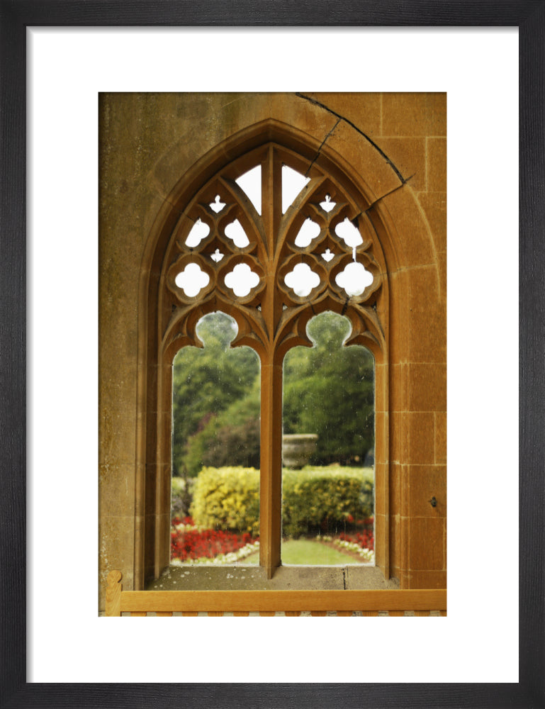 A view of the terrace garden planting through the tracery of one of th ...