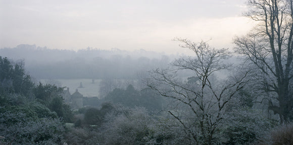 View through frosty tree branches towards the castle at Scotney Castle Garden