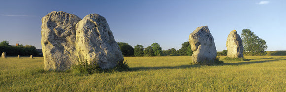A close view of three large standing stones at Avebury