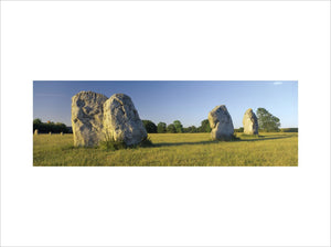 A close view of three large standing stones at Avebury