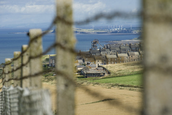 Looking through barbed wire fencing towards Whitehaven, Cumbria