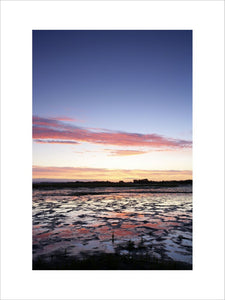 A view at sunrise over the saltmarsh at East Head