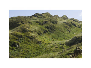 Shepherds appearing as tiny specks on the Snowdonia hillside of the Hafod Y Llan farm