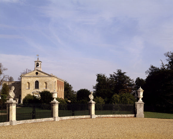 The forecourt and Church at Wimpole Hall with mounted busts and urns in the railings