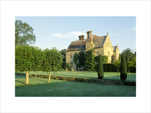 View of the house at Bateman's from across the lawn in late afternoon light