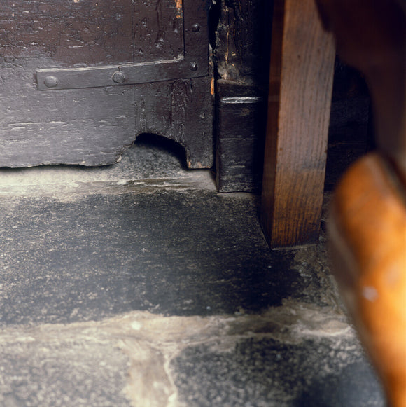Close shot of a mousehole under the door at Hill Top, Beatrix Potter's home in Sawrey, Cumbria