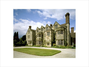 The garden front of Benthall Hall, a 16th century stone house, with a grassy forecourt