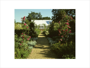 Double border by G.S.Thomas on both sides of a path leading from the Pool garden towards the Orangery in the garden at Peckover House.