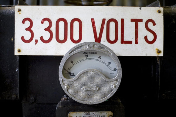 Close up of mining equipment - an electricty meter and volatge notice