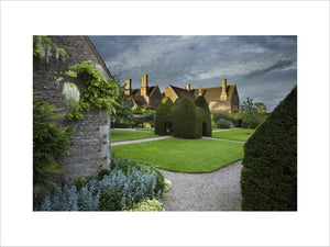 Yew topiary house on the large lawn, or pleasaunce, at the fifteenth-century Great Chalfield Manor, Wiltshire