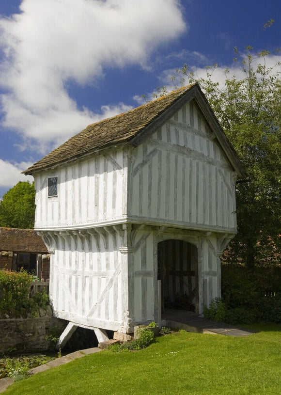 The timber-framed Gatehouse over the moat to Lower Brockhampton House