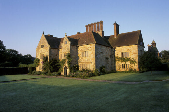 The yellow stone exterior of Bateman's in brilliant sunlight, East Sussex