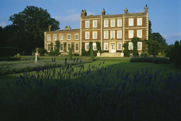 View of the front entrance of Gunby Hall with lawns and lavender beds in the centre and in the foreground