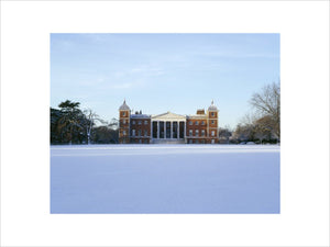 The East front of Osterley Park, reconstructed by Robert Adam in 1760s, seen over a snowy lawn showing figured pediment, Corinthian columns, balustrade and snow-covered terrace