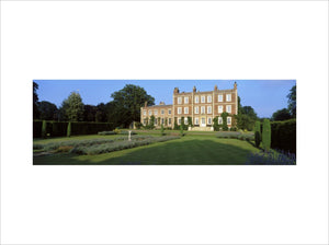 Nearer oblique view of the front of Gunby Hall showing lawns and lavender beds with a sundial