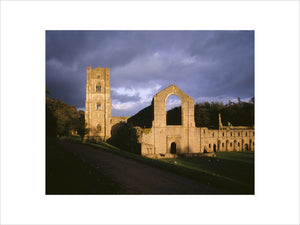 Spotlights light up part of Fountains Abbey and the Cellarium at dusk