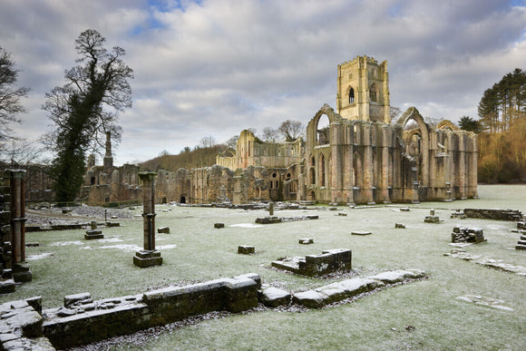 A winter view towards the east end of the Abbey church showing the great east window arch at Fountains Abbey, North Yorkshire