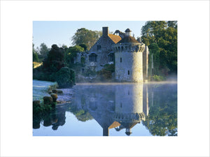 Early morning mist rises above the moat on a frosty winter's day at Scotney Castle, Lamberhurst, Kent