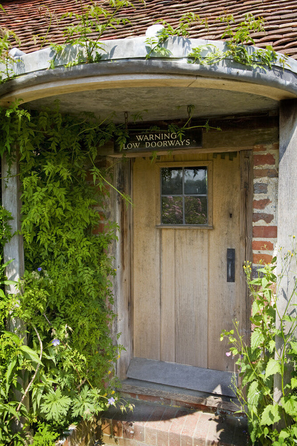 Pretty wooden door, with a warning sign, at Alfriston Clergy House in East Sussex