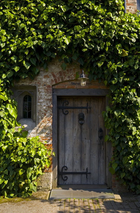 The wooden entrance door in the Courtyard at Baddesley Clinton, Warwickshire