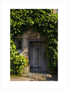 The wooden entrance door in the Courtyard at Baddesley Clinton, Warwickshire
