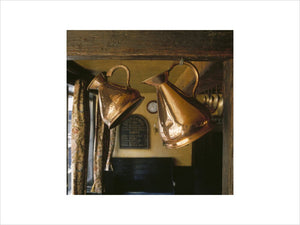 Copper pots hanging in the George Inn, Southwark, the only remaining galleried inn in London