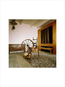 View from the window towards the bed and back wall showing the original doorway with spinning wheel