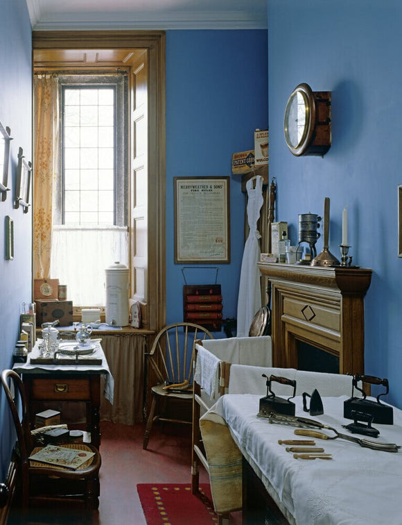 A room view of the Nursery Scullery showing the blue painted walls and a window at the rear of the room at Lanhydrock