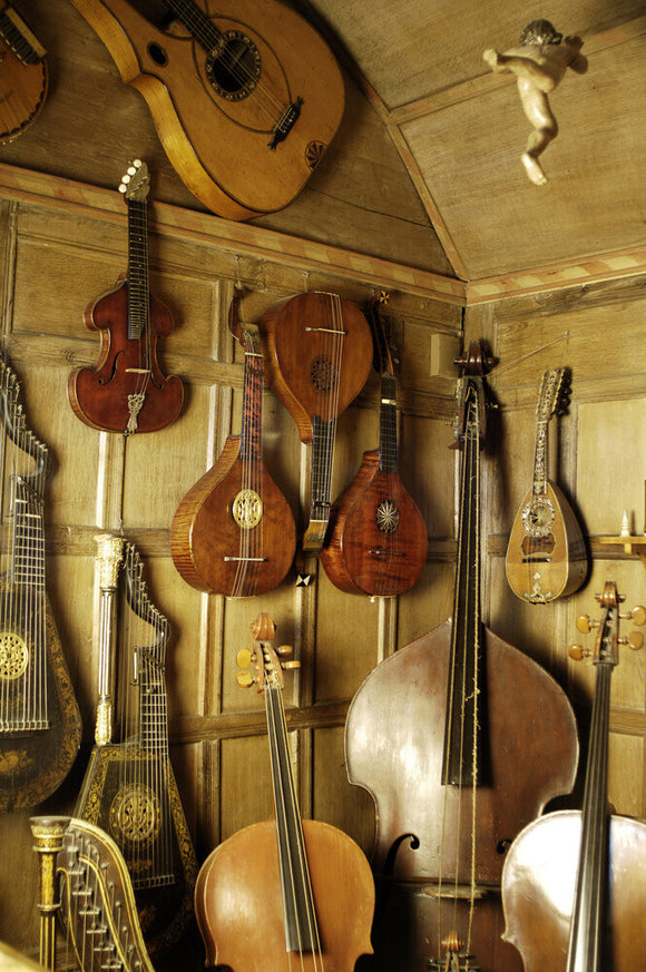 A mixed selection of stringed instruments, part of the musical instrument collection at Snowshill Manor, Gloucestershire