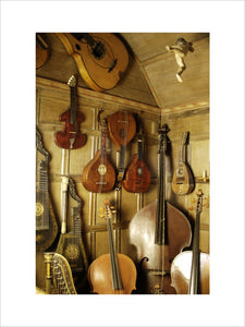 A mixed selection of stringed instruments, part of the musical instrument collection at Snowshill Manor, Gloucestershire