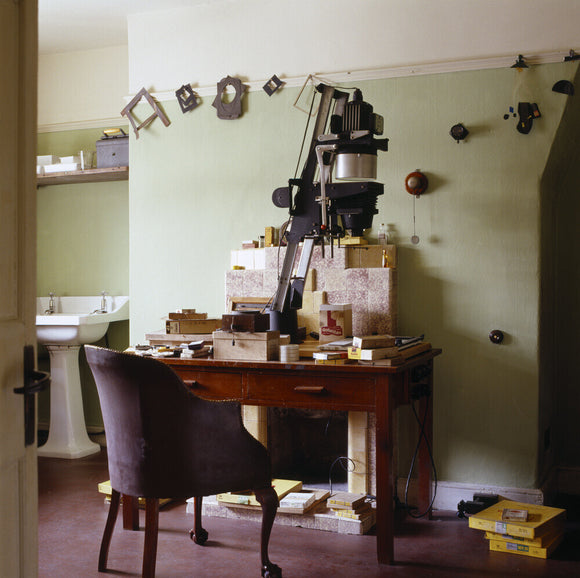The Dark Room at 59 Rodney Street, Liverpool, the E. Chambre Hardman Studio, House and Photographic Collection - showing a desk, chair and enlarging equipment.