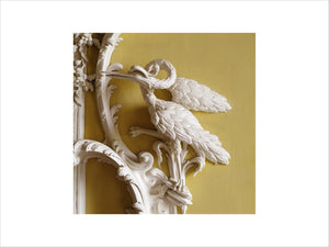 Detail of carved crane or heron at bottom corner of wall niche in the North Hall at Claydon House