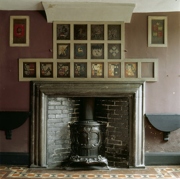 Painted coats of arms, above the fireplace, in the Tribes' Room at Erddig