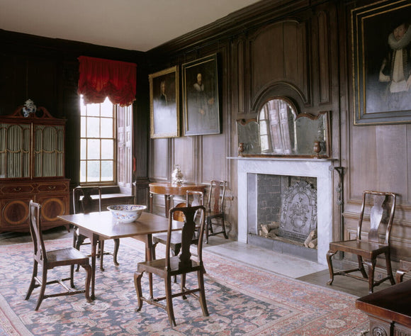 The Dining Room at Canons Ashby including the chimney-piece, walnut-framed mirror, dining table and secretaire bookcase