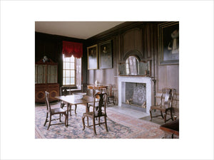 The Dining Room at Canons Ashby including the chimney-piece, walnut-framed mirror, dining table and secretaire bookcase