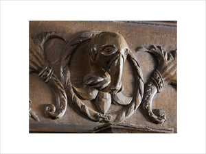 Carved head of an elephant in the oak panelling in the Dining Room at Coughton Court, Warwickshire