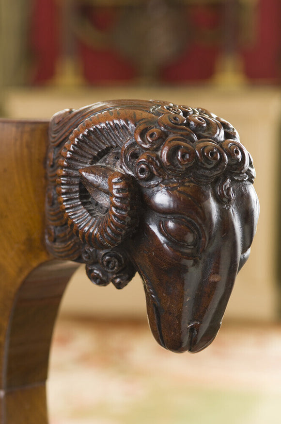 Detail of a carved wooden ram's head on an armchair in the Sitting Room at Hinton Ampner, Hampshire