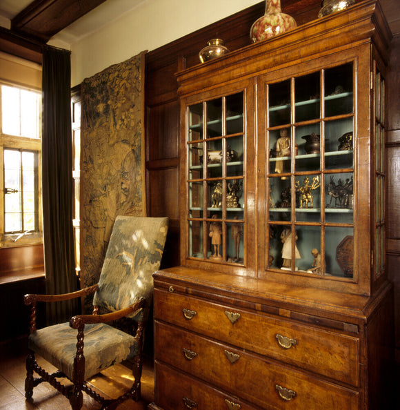 Close-up of the walnut bureau in the Parlour, containing Indian artefacts and works of art collected by Kipling