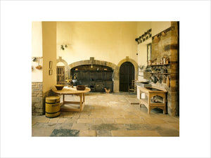 Canons Ashby - The Kitchen with Victorian cast iron range and cooking utensils and stone flagged floor