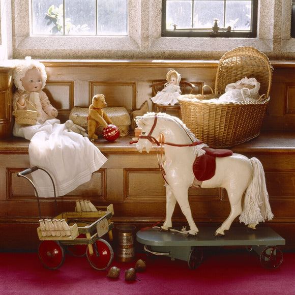 A view of the Night Nursery including a rocking horse and dolls at Lanhydrock