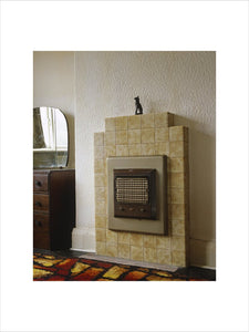 1930's electric fire fitted into a tiled fireplace in a rear bedroom at John Lennon's home, 'Mendips', Liverpool
