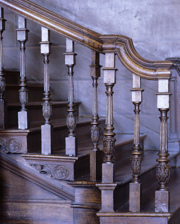 Detail of the carved oak balusters and tread ends at the foot of the Painted Staircase in the Hall at Hanbury Hall, Worcestershire