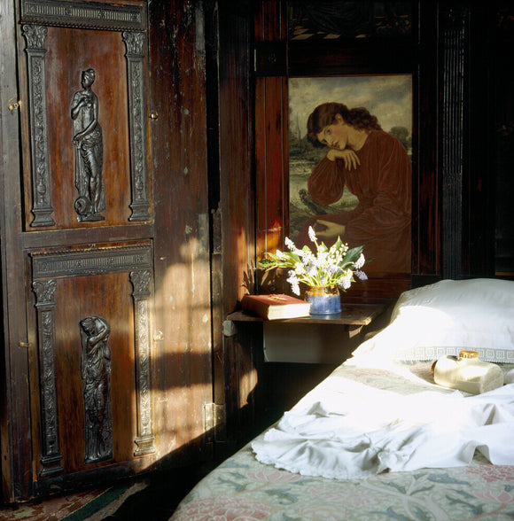 A corner of the Oak Room at Wightwick Manor with period carvings and paintings based on early Rossetti works
