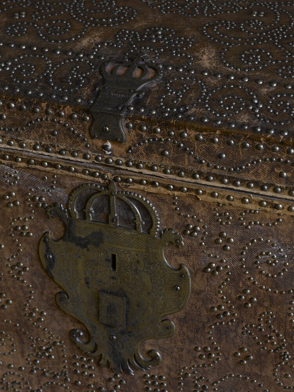 Close view of the hasp with a royal crown on one of the moroccan leather-covered nailed trunks c.1660-1720 at Hardwick Hall, Derbyshire.