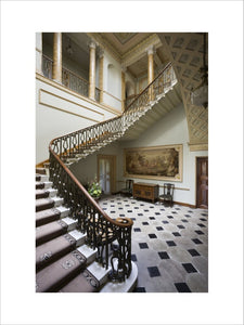The sweeping staircase with bronzed balustrading in the Staircase Hall at Berrington Hall, Herefordshire