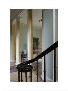 Detail of the wrought iron balustrade of the staircase, and the two Doric columns beyond, of the Entrance Hall at Newark Park, Gloucestershire