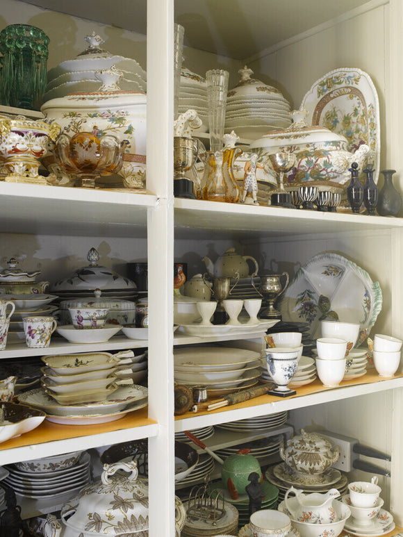 A cupboard of assorted chinaware in the Winter Dining Room at Greenway, Devon