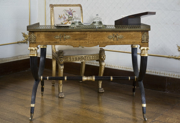 A small French table with bronze edged top and black arched legs in the Boudoir at Berrington Hall, Herefordshire